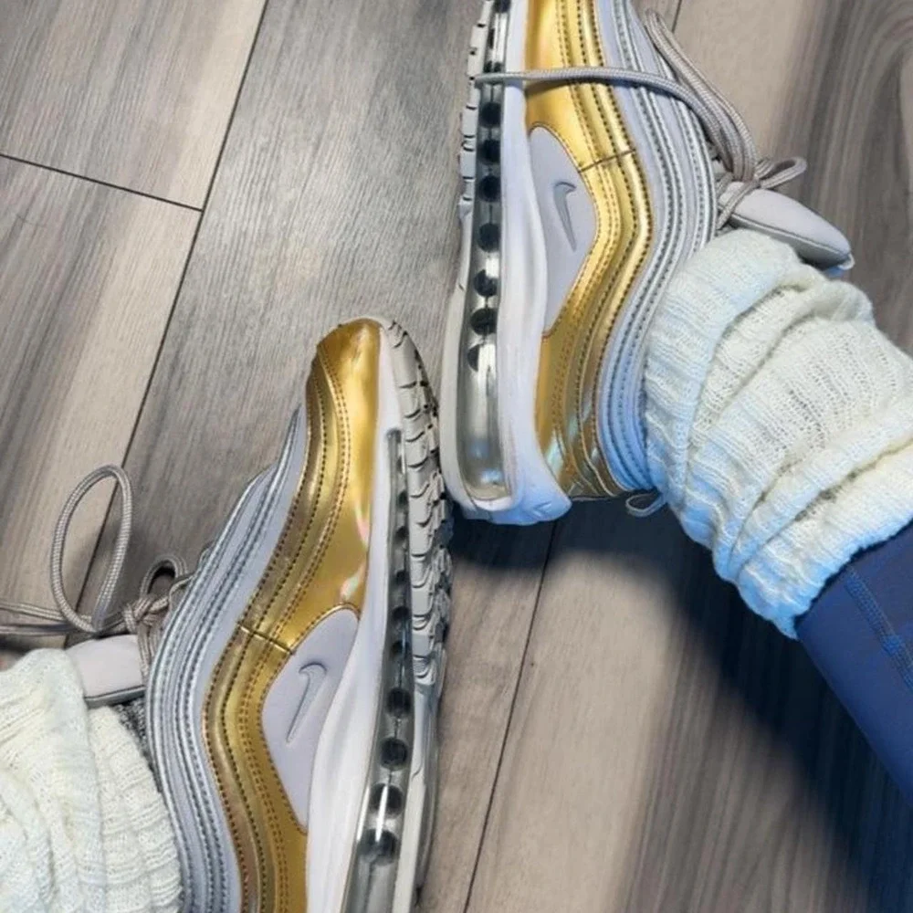 Nike Air Max 97 sneakers in gold and white with silver accents